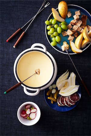 simsearch:600-07311268,k - Cheese fondue with vegetables and fruit for dipping on a dark blue background Stock Photo - Premium Royalty-Free, Code: 600-09155602