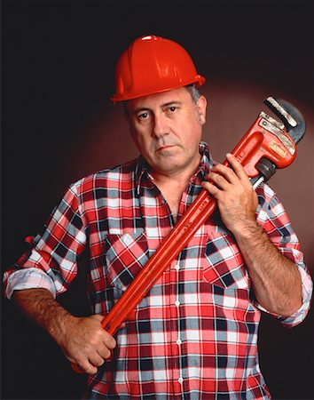 pipe wrench - Portrait of Male Worker Holding Wrench Stock Photo - Premium Royalty-Free, Code: 600-00027396