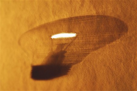 simsearch:640-01362739,k - Shadow of Lightbulb on Textured Surface Stock Photo - Premium Royalty-Free, Code: 600-00057824