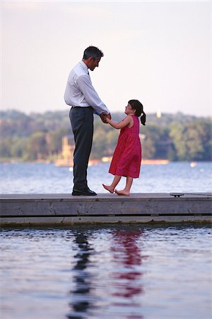 Father and Daughter Standing on Dock, Holding Hands Stock Photo - Premium Royalty-Free, Code: 600-00064730