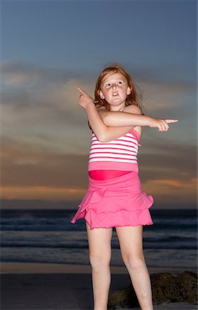 Girl on the Beach, Pointing In Different Directions Stock Photo - Premium Royalty-Free, Code: 600-00796491