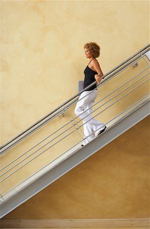 people going down stairs side view - Woman Walking Down Stairs Stock Photo - Premium Royalty-Free, Code: 600-00824104