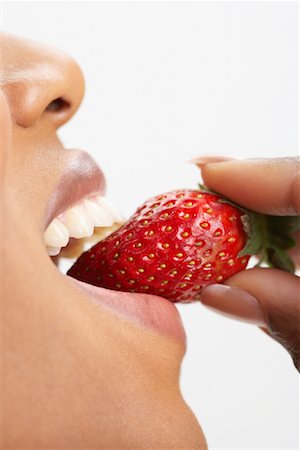 simsearch:873-06440787,k - Woman Eating Strawberry Stock Photo - Premium Royalty-Free, Code: 600-00823910
