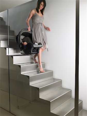 Mother Carrying Baby Down Stairs Stock Photo - Premium Royalty-Free, Code: 600-00847873