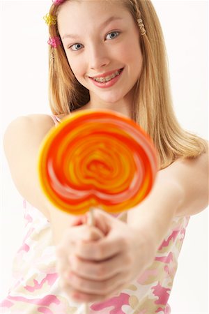 Girl Holding Lollipop Stock Photo - Premium Royalty-Free, Code: 600-00847932
