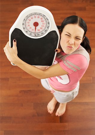 simsearch:600-02245725,k - Woman Holding Scale Stock Photo - Premium Royalty-Free, Code: 600-00848068