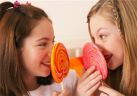 Girl's Holding Lollipops Stock Photo - Premium Royalty-Free, Code: 600-00866096