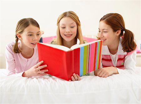 simsearch:600-00866293,k - Girls Lying on Bed, Reading Book Stock Photo - Premium Royalty-Free, Code: 600-00866166