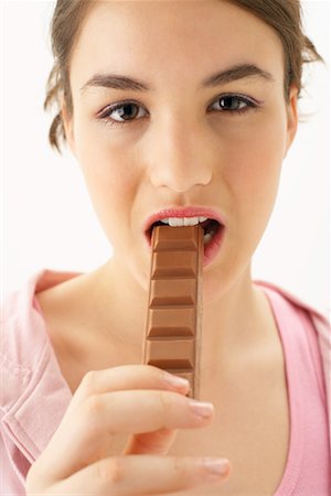 Girl Eating Chocolate Stock Photo - Premium Royalty-Free, Code: 600-00866250