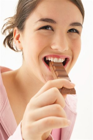 Girl Eating Chocolate Stock Photo - Premium Royalty-Free, Code: 600-00866251