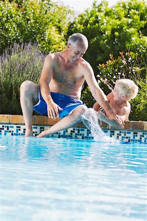 Father and Son by Swimming Pool Stock Photo - Premium Royalty-Free, Code: 600-00866647