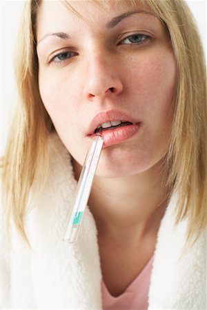 flu season - Woman Taking Her Temperature Stock Photo - Premium Royalty-Free, Code: 600-00917306