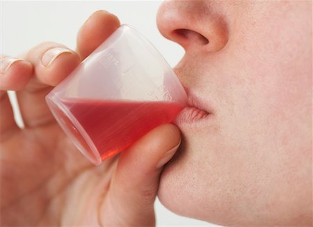 simsearch:700-02700162,k - Woman Drinking Cough Syrup Foto de stock - Sin royalties Premium, Código: 600-00917300