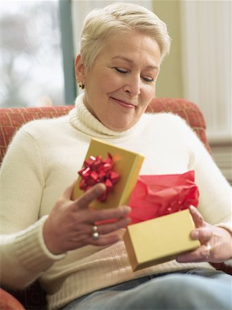 Woman Opening Gift Stock Photo - Premium Royalty-Free, Code: 600-00911849