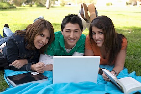 simsearch:600-02973192,k - Young People Lying Down On Blanket in the Park with Computer Stock Photo - Premium Royalty-Free, Code: 600-00912239
