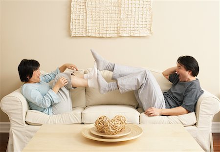 simsearch:600-03333357,k - Couple Playing on Sofa Stock Photo - Premium Royalty-Free, Code: 600-00934067