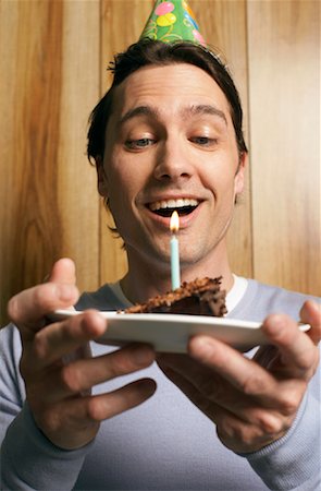 simsearch:600-02461257,k - Man Holding Slice of Birthday Cake with Candle Stock Photo - Premium Royalty-Free, Code: 600-00934367