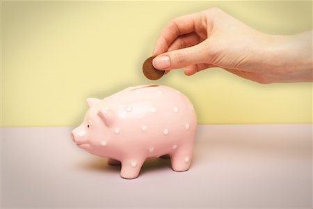 simsearch:600-02797971,k - Person's Hand Putting Coin in Piggy Bank Stock Photo - Premium Royalty-Free, Code: 600-00934731
