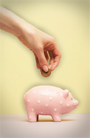 simsearch:600-02797971,k - Person's Hand Putting Coin in Piggy Bank Stock Photo - Premium Royalty-Free, Code: 600-00934733