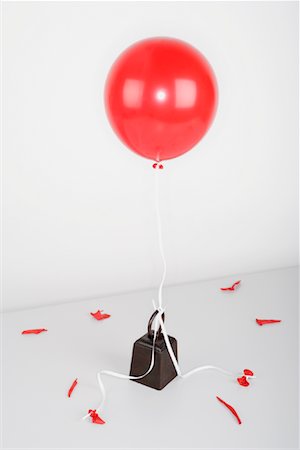 Helium Balloon Tied to Weight Stock Photo - Premium Royalty-Free, Code: 600-00933885