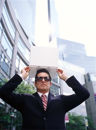 stealing (not forced entry) - Businessman Holding Laptop Computer on Head Stock Photo - Premium Royalty-Free, Code: 600-00948869