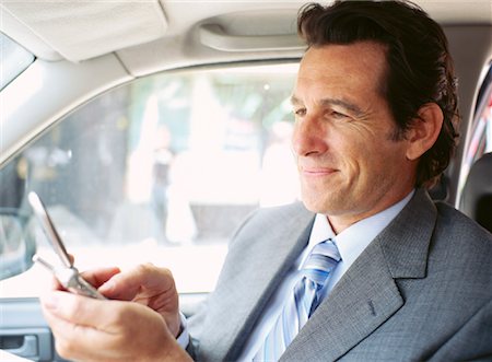 simsearch:700-00695760,k - Businessman in Car, Using Cell Phone Stock Photo - Premium Royalty-Free, Code: 600-00948935
