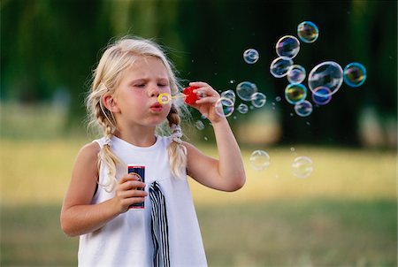 foreground (something in the foreground) - Little Girl Blowing Bubbles Stock Photo - Premium Royalty-Free, Code: 600-00954459