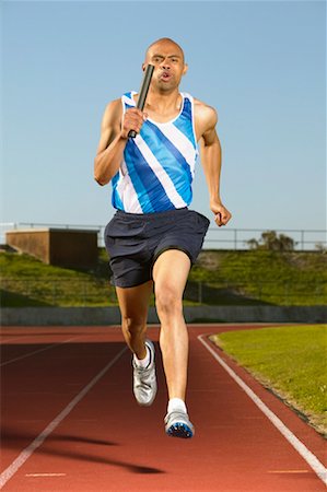 simsearch:628-05817723,k - Runner Holding Baton Stock Photo - Premium Royalty-Free, Code: 600-00984012