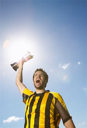 sky's the limit - Portrait of Soccer Player Holding Trophy Stock Photo - Premium Royalty-Free, Code: 600-00984029