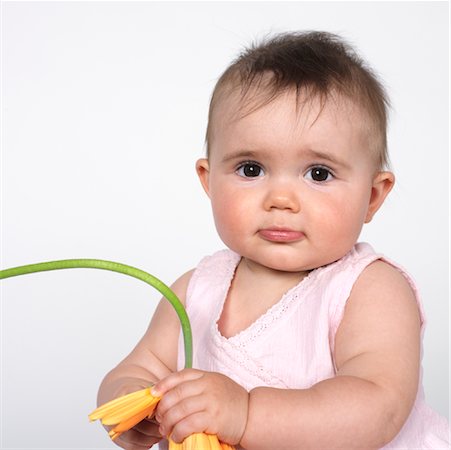 simsearch:600-01172751,k - Baby with Gerbera Daisy Stock Photo - Premium Royalty-Free, Code: 600-00983807