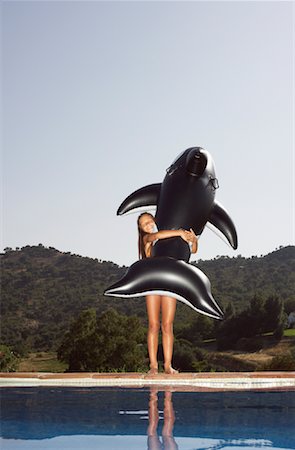Girl Carrying Inflatable Whale Stock Photo - Premium Royalty-Free, Code: 600-01036694