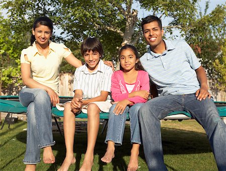 simsearch:600-01083008,k - Family Sitting on Trampoline Stock Photo - Premium Royalty-Free, Code: 600-01036894