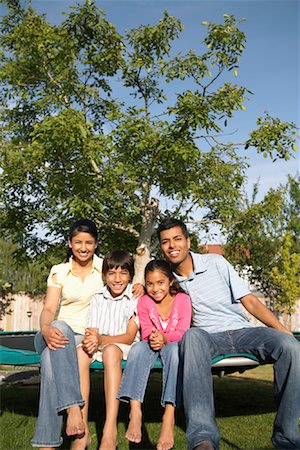 simsearch:600-01083008,k - Family Sitting on Trampoline Stock Photo - Premium Royalty-Free, Code: 600-01036895