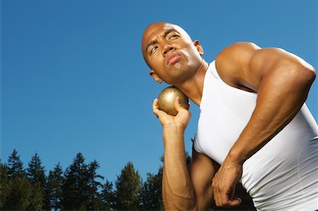 filipino (male) - Man About to Throw Shot Put Stock Photo - Premium Royalty-Free, Code: 600-01037127