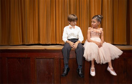 Boy and Girl Sitting on Stage Stock Photo - Premium Royalty-Free, Code: 600-01037558
