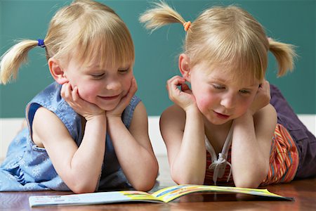 simsearch:700-00150473,k - Twin Sisters Reading Book Stock Photo - Premium Royalty-Free, Code: 600-01037662