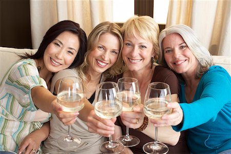 simsearch:700-01185080,k - Friends Drinking Wine in Living Room Stock Photo - Premium Royalty-Free, Code: 600-01041789