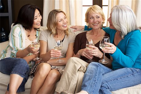 simsearch:700-01185080,k - Friends Drinking Wine in Living Room Stock Photo - Premium Royalty-Free, Code: 600-01041790