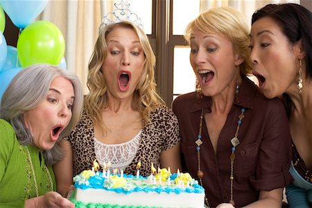 simsearch:600-02671208,k - Friends Blowing out Birthday Candles Stock Photo - Premium Royalty-Free, Code: 600-01041814