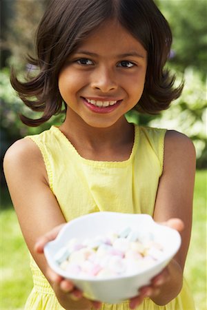 Girl Holding Dish of Candy Stock Photo - Premium Royalty-Free, Code: 600-01041973