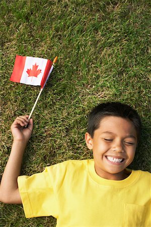 simsearch:700-02264741,k - Portrait of Boy Lying on Grass, Holding Canadian Flag Stock Photo - Premium Royalty-Free, Code: 600-01042044