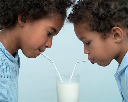 delicious enjoying food - Children Sharing a Glass of Milk Stock Photo - Premium Royalty-Free, Code: 600-01043041