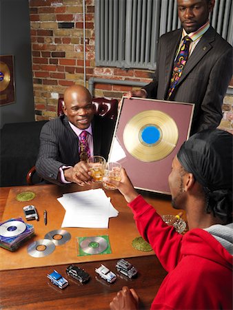 Record Executives Presenting Gold Record to Hip Hop Artist Stock Photo - Premium Royalty-Free, Code: 600-01043287