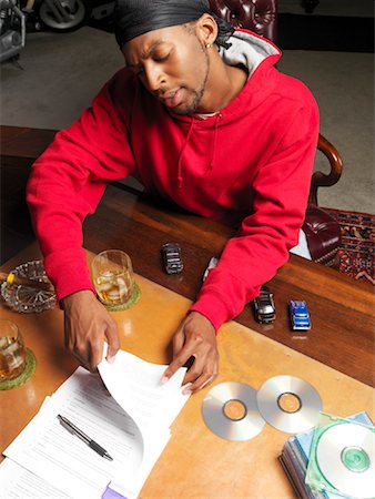 simsearch:700-00045560,k - Hip Hop Artist Reading Contract Stock Photo - Premium Royalty-Free, Code: 600-01043283
