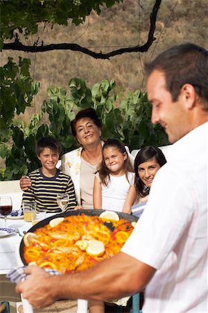 simsearch:673-02139604,k - Man Serving Family Meal Outdoors Stock Photo - Premium Royalty-Free, Code: 600-01043399