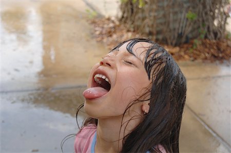 sticking out her tongue - Portrait of Girl Outdoors, The Solar Living Institute, Hopland, California, USA Stock Photo - Premium Royalty-Free, Code: 600-01072458