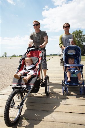 Fathers with Babies in Strollers Walking Along Boardwalk Stock Photo - Premium Royalty-Free, Code: 600-01073129