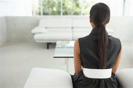 Woman Sitting in Living Room Stock Photo - Premium Royalty-Free, Code: 600-01073225