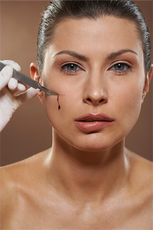 simsearch:700-01073337,k - Woman Having Face Cut with Scalpel Stock Photo - Premium Royalty-Free, Code: 600-01073387