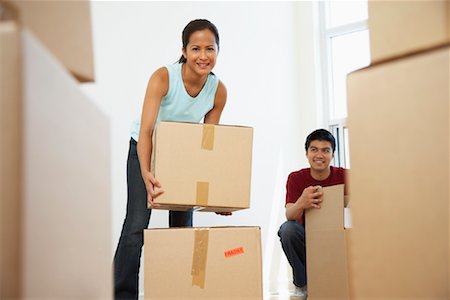 simsearch:600-01073479,k - Couple Packing Boxes Stock Photo - Premium Royalty-Free, Code: 600-01073477